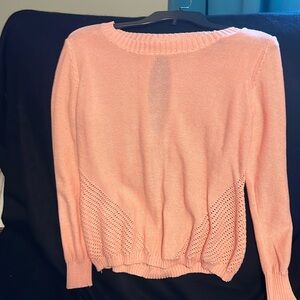 Cute pullover sweater with opening in back and silk-like bows.
